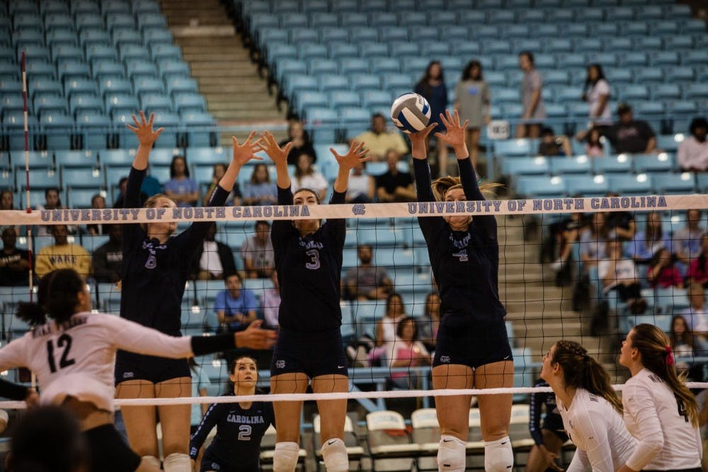 Taylor Borup (4) jumps in the air for a block against Wake Forest on Sunday at Carmichael Arena.