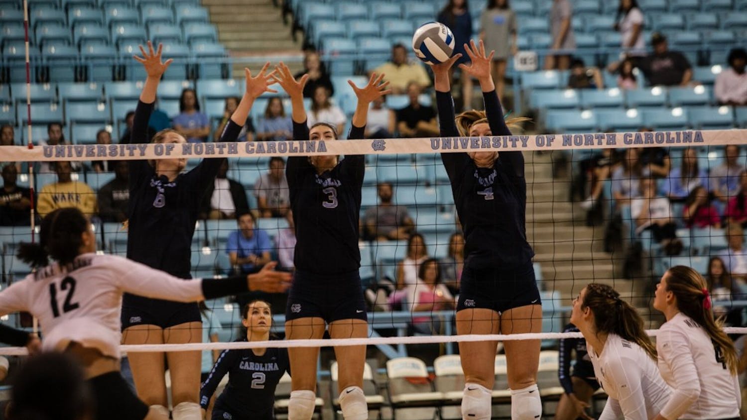 Taylor Borup (4) jumps in the air for a block against Wake Forest on Sunday at Carmichael Arena.