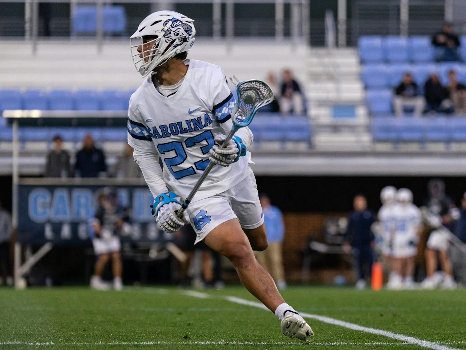 UNC sophomore midfielder Ty English (23) runs with the ball during the men's lacrosse game against High Point on Wednesday, March 22, 2023, at Dorrance Field. UNC beat High Point 16-9.