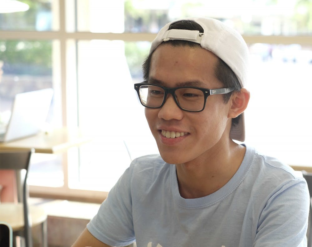 <p>Murphy Liu poses for picture during an interview with Karli Krasnipol at Alpine Bagel. Liu has answered questions posted by other students on facebook.</p>