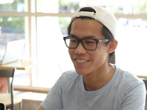 Murphy Liu poses for picture during an interview with Karli Krasnipol at Alpine Bagel. Liu has answered questions posted by other students on facebook.