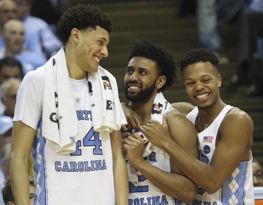 <p>North Carolina teammates Justin Jackson (44), Joel Berry (2) and Nate Britt (0) share a laugh after defeating Duke in the Smith Center on Saturday.</p>
