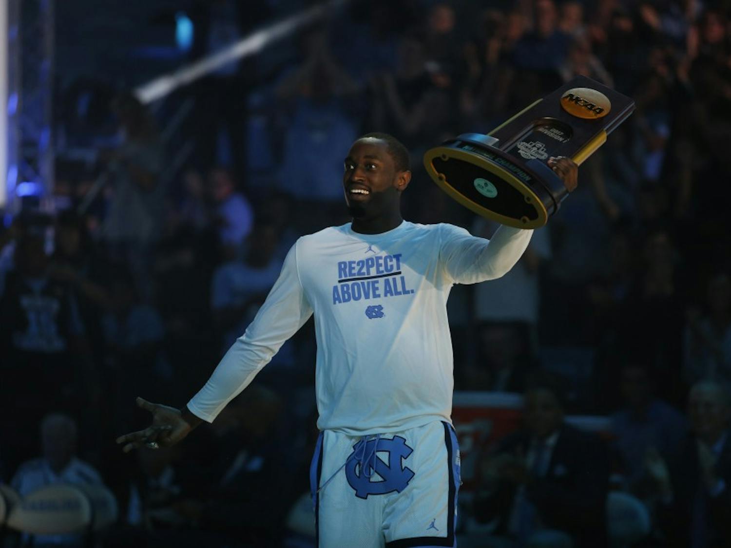 Theo Pinson presents the 2017 national championship trophy at Late Night With Roy on Friday night.