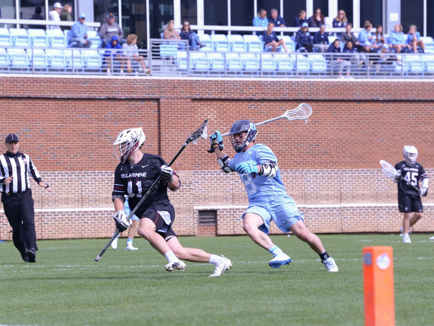 Senior attackman Nicky Soloman (8) chases his opponent during Carolina Men's Lacrosse's home game against Bellarmine on Saturday, March 26, 2022. UNC won 15-8.