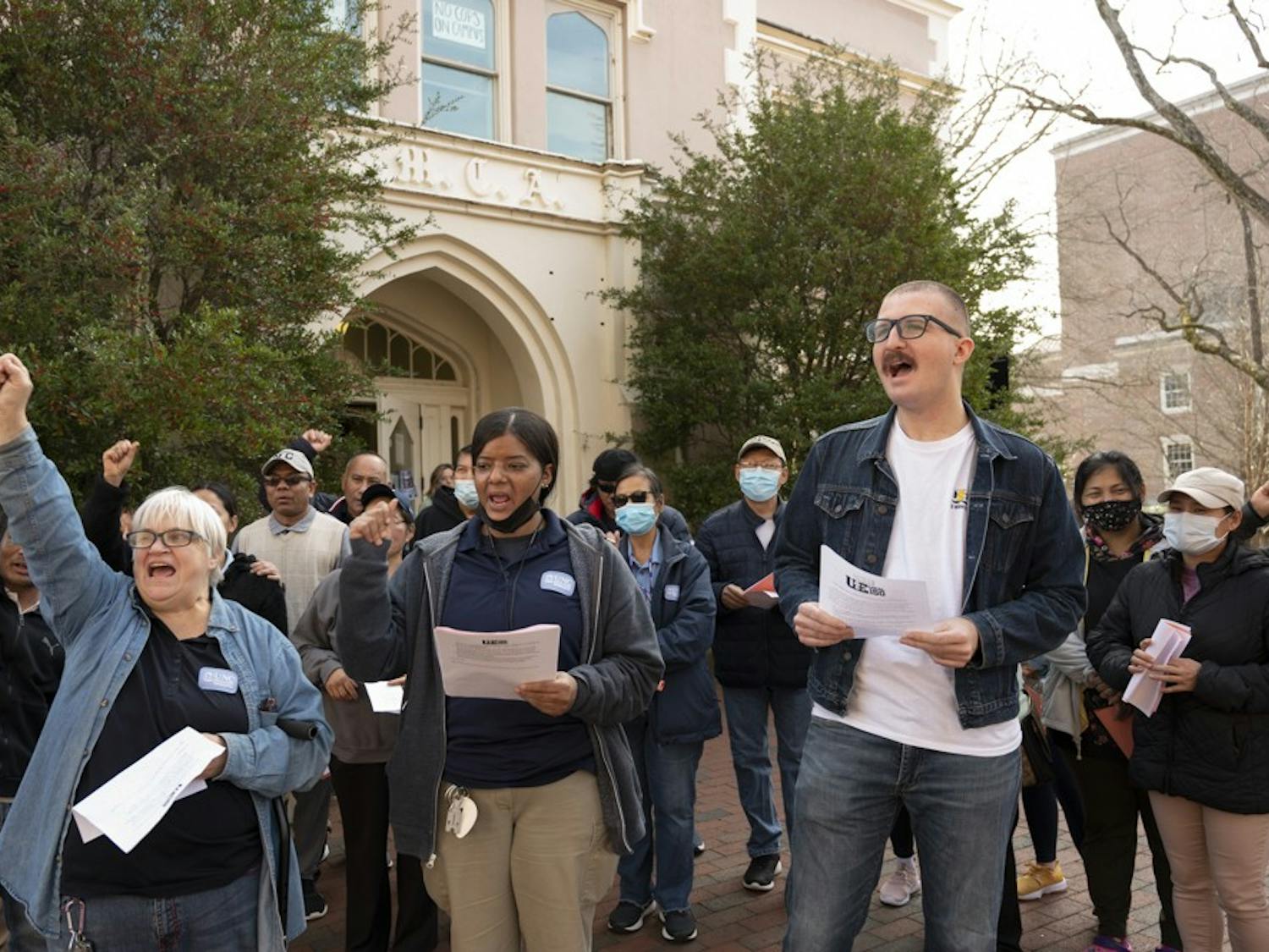 Tracy Harter, Vinyasa Burnette and Trey Anthony call out for better pay for UNC Housekeepers outside of the Campus Y on Wednesday, Jan. 18, 2023.