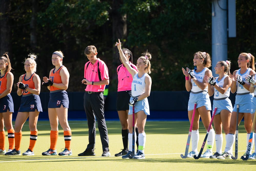 UNC senior forward Erin Matson (1) raises her hand towards the crowd during her introduction at the women's field hockey game against Syracuse on Oct. 14, 2022 at Karen Shelton Stadium. UNC beat Syracuse 6-1.