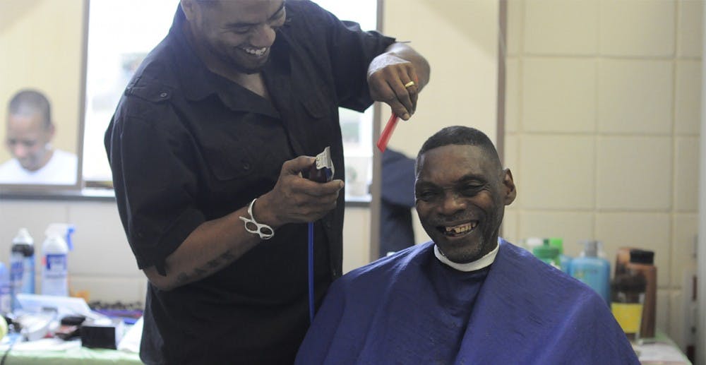 Barber, Mark Holt, gives Phillip Gilliam a free haircut at Project Connect, a one-day, one-stop center that connects people whom are at risk of homelessness with a broad range of long-term services.  