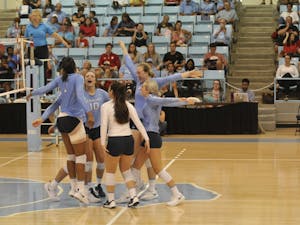 The UNC volleyball team celebrates scoring a point against NC State on Wednesday, Sept. 26 in Carmichael Arena.