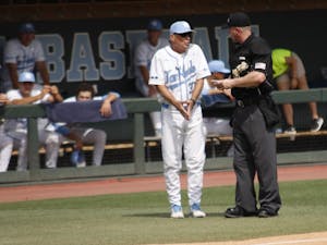 UNC baseball head coach Mike Fox argues with the umpire after a call  during the first round of the regional championships on Friday May 31, 2019. UNC beat UNCW 7-6. 