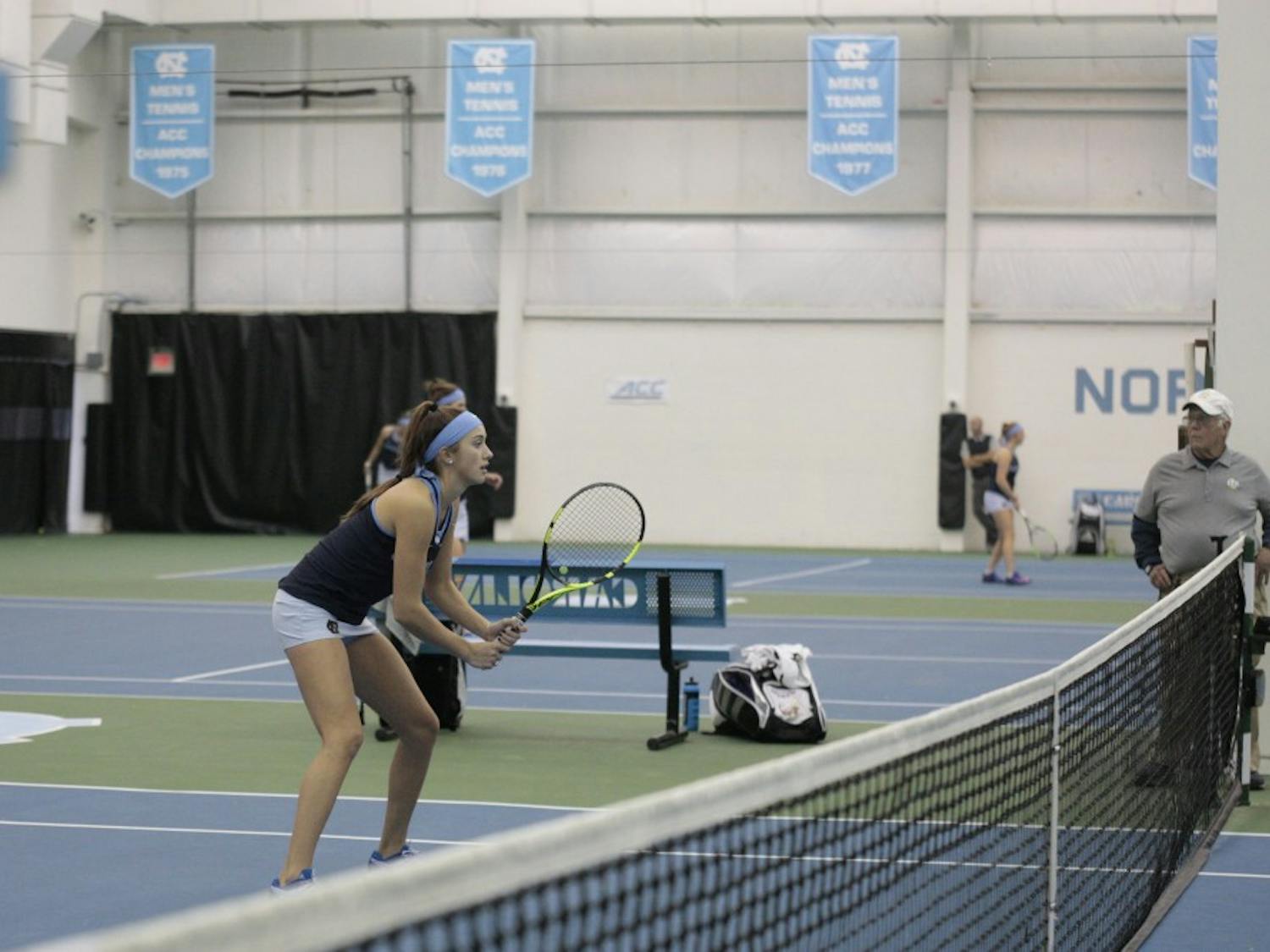 First-year Cameron Morra prepares to receive a serve during a doubles match against East Carolina University at the Cone-Kenfield Tennis Center in Chapel Hill, NC on Wednesday, Jan. 23, 2019. Morra and her partner, Makenna Jones, won both sets in the match.&nbsp;