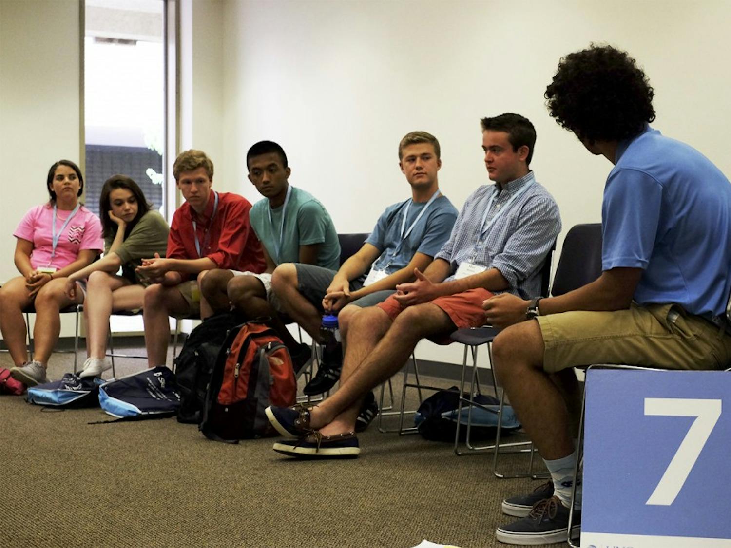 Parker Martin, an orientation leader, leads a discussion after a presentation on Monday.