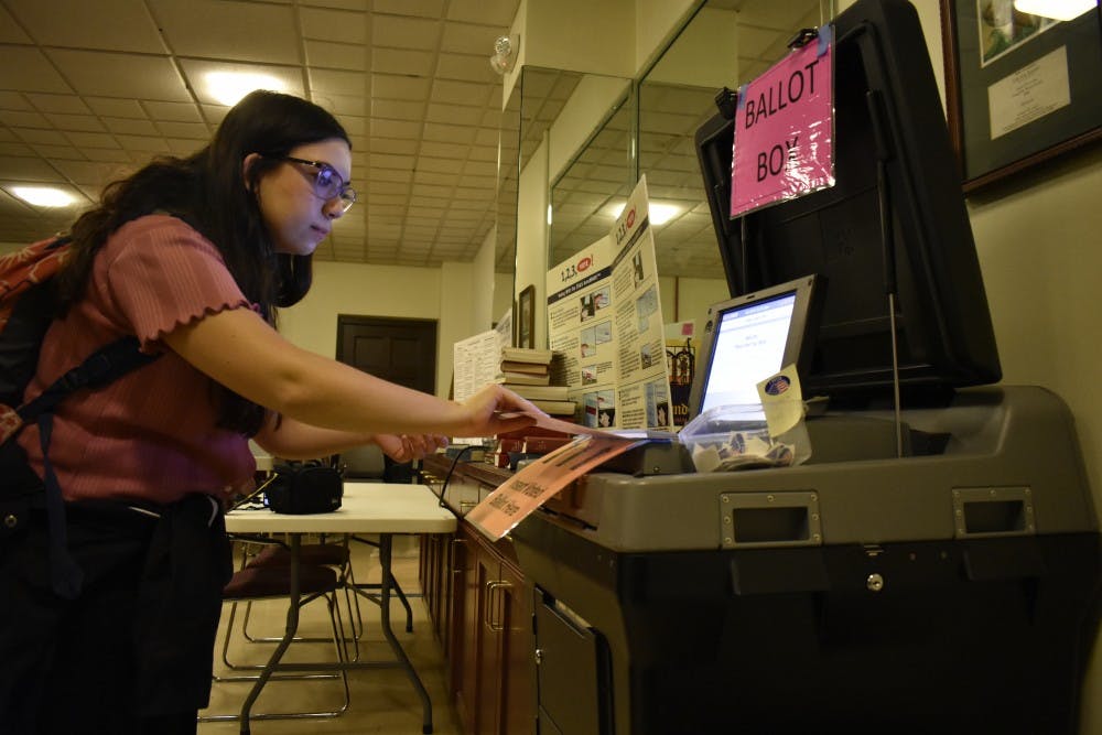 <p>Media and Journalism student Mitra Norowzi submits her ballot at the Chapel of the Cross church at 304 E. Franklin St. on Oct. 23, 2018. The Chapel of the Cross serves as an early voter location close to the University of North Carolina at Chapel Hill's campus.&nbsp;</p>