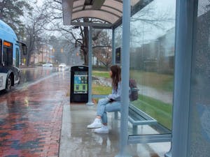 A student waits for the bus at the new South Road bus stop on February 11, 2021. Chapel Hill Transit recently installed new stops and coverings for their buses.