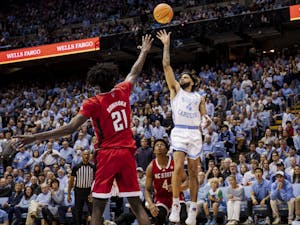 UNC junior guard RJ Davis (4) goes up for a floater during a basketball game against N.C. State on Saturday, Jan. 21, 2023, in the Dean E. Smith Center. UNC won 80-69.