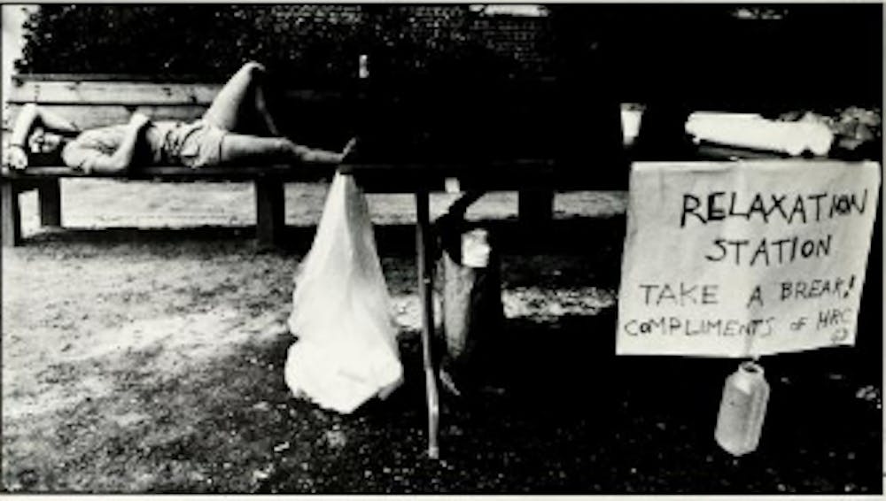 A student rests on a bench during move-in weekend, 1988. Courtesy of UNC's&nbsp;Yackety Yack yearbook.
