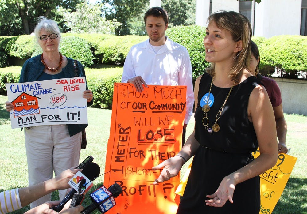 	<p>Jenny Marienau, field organizer for 350.org, voices her concerns about the Coastal Management Policies bill outside the NC legislature building on Tuesday.</p>