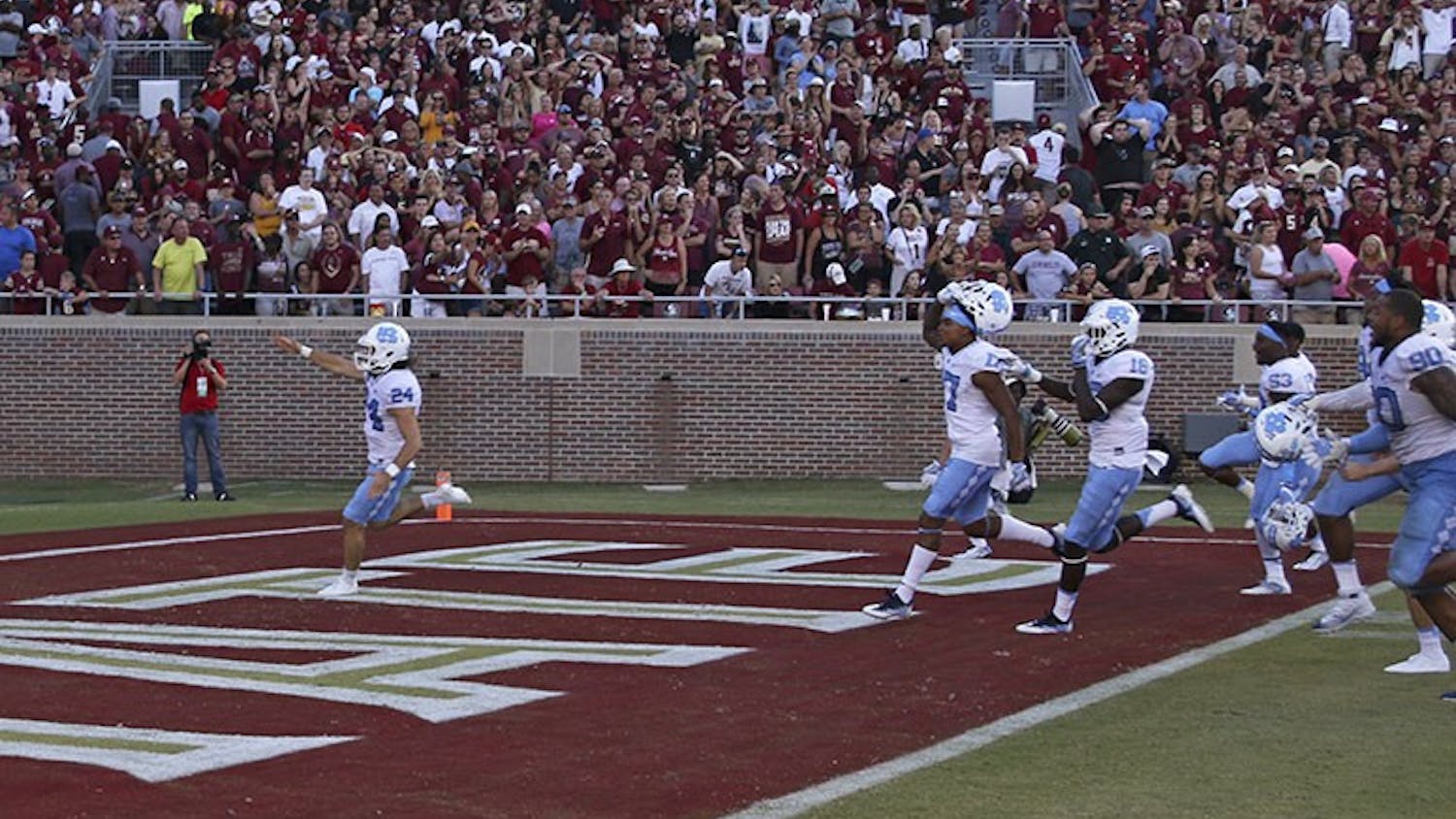 UNC kicker Nick Weiler (24) imitates the Florida State "Tomahawk Chop" as he celebrates kicking a career high 54-yard field goal as time expired to lift UNC over Florida State.