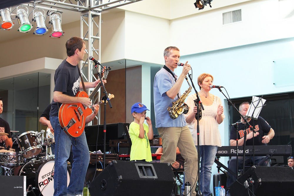 The Buzztown Band performs at the Not So Normal 5K at University Mall on Sunday.