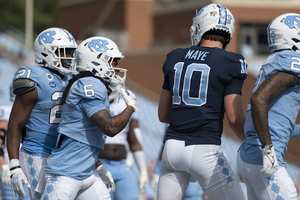 <p>UNC junior wide receiver Nate McCollum (6) celebrates with UNC sophomore quarterback Drake Maye (10) after they scored a touchdown during the Spring Game in Kenan Stadium at on Saturday, April 15, 2023.</p>