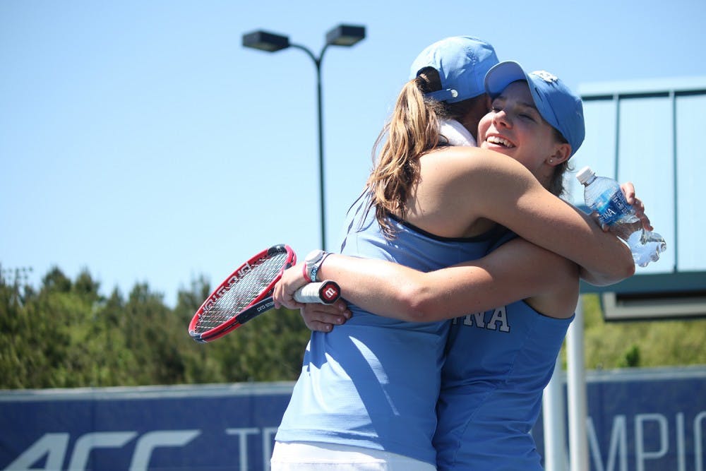 Freshman Jessie Aney (right) embraces junior Hayley Carter after winning her singles match in three sets during the ACC Championship match on Sunday in Cary. The UNC women's tennis team defeated the University of Miami 4-2 to capture the title.