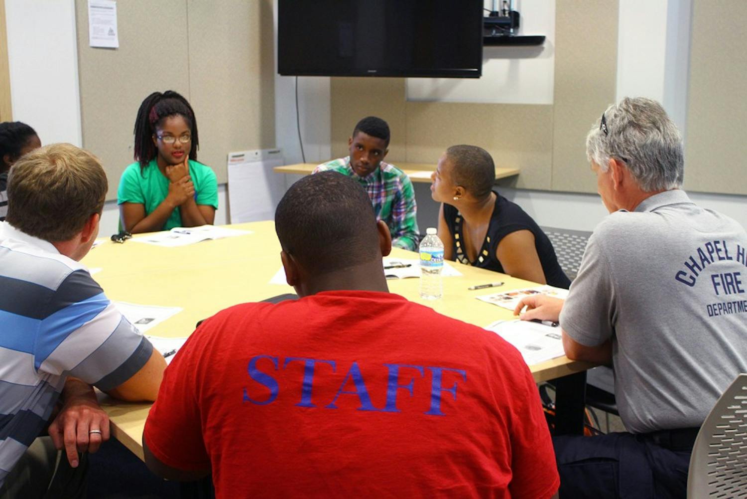 (Far left) Hargraves Community Center counselor Jazmine Mason-Carter brainstorms safety ideas with other trainees.