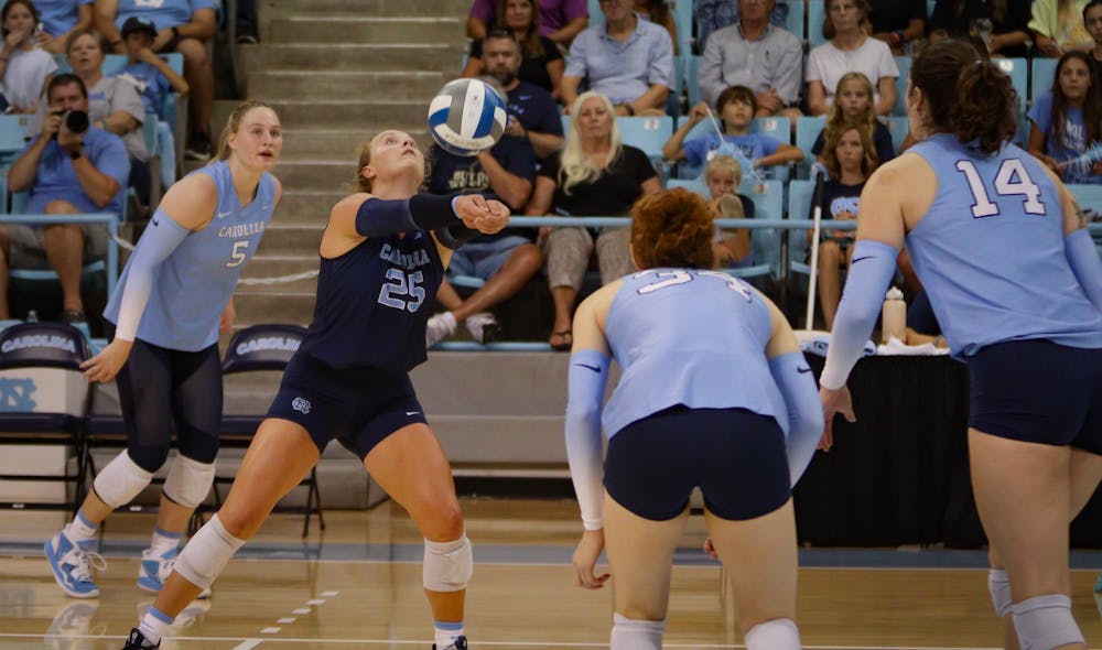 First-year libero Maddy May (25) bumps the ball over the net. UNC beat Arizona 3-2 at home on Saturday, Sept. 3, 2022.