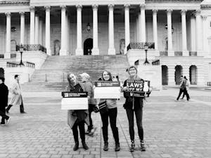 Kate Townsend, Emily Hagstrom and Amanda Witwer hold up their protest signs at the Women's March on Washington.
