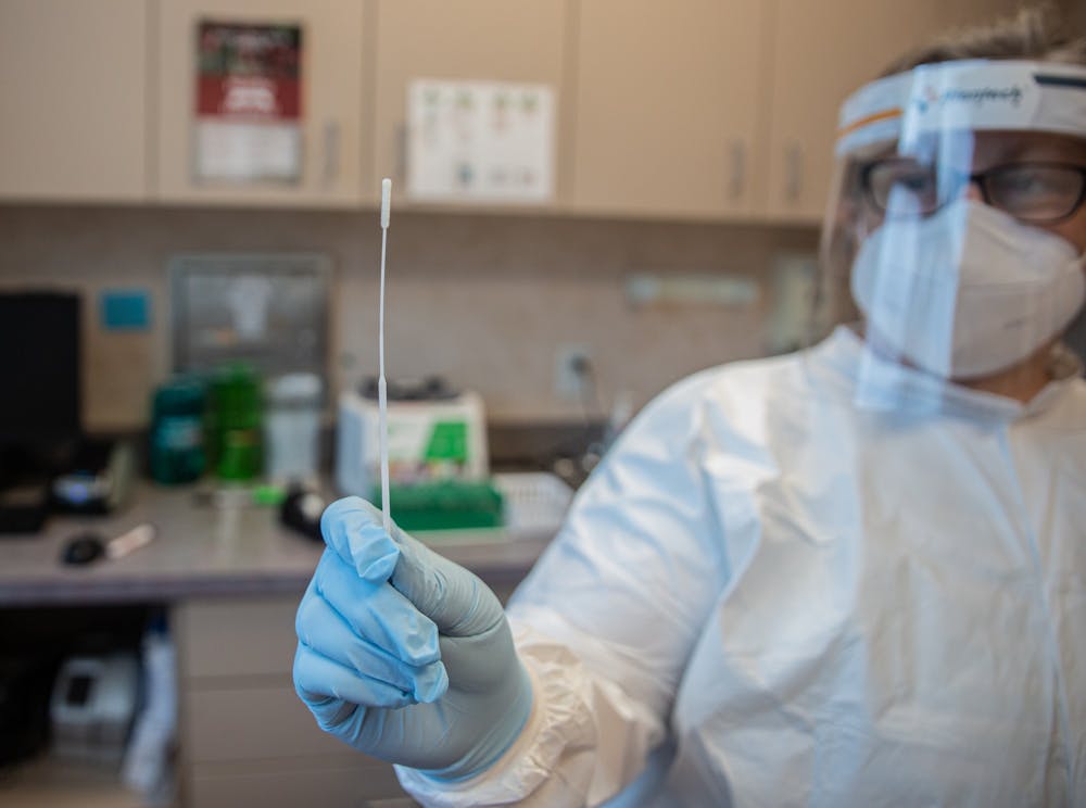<p>Wilson, N.C. resident Dr. Natalie Doyle holds up a COVID-19 testing swab on Sunday, Nov. 15, 2020.</p>