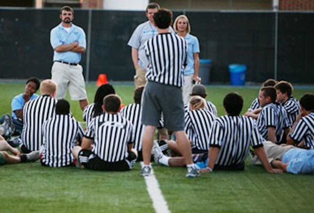 Newly hired referees are trained by Campus Recreation staff on Thursday evening at Fetzer Field.