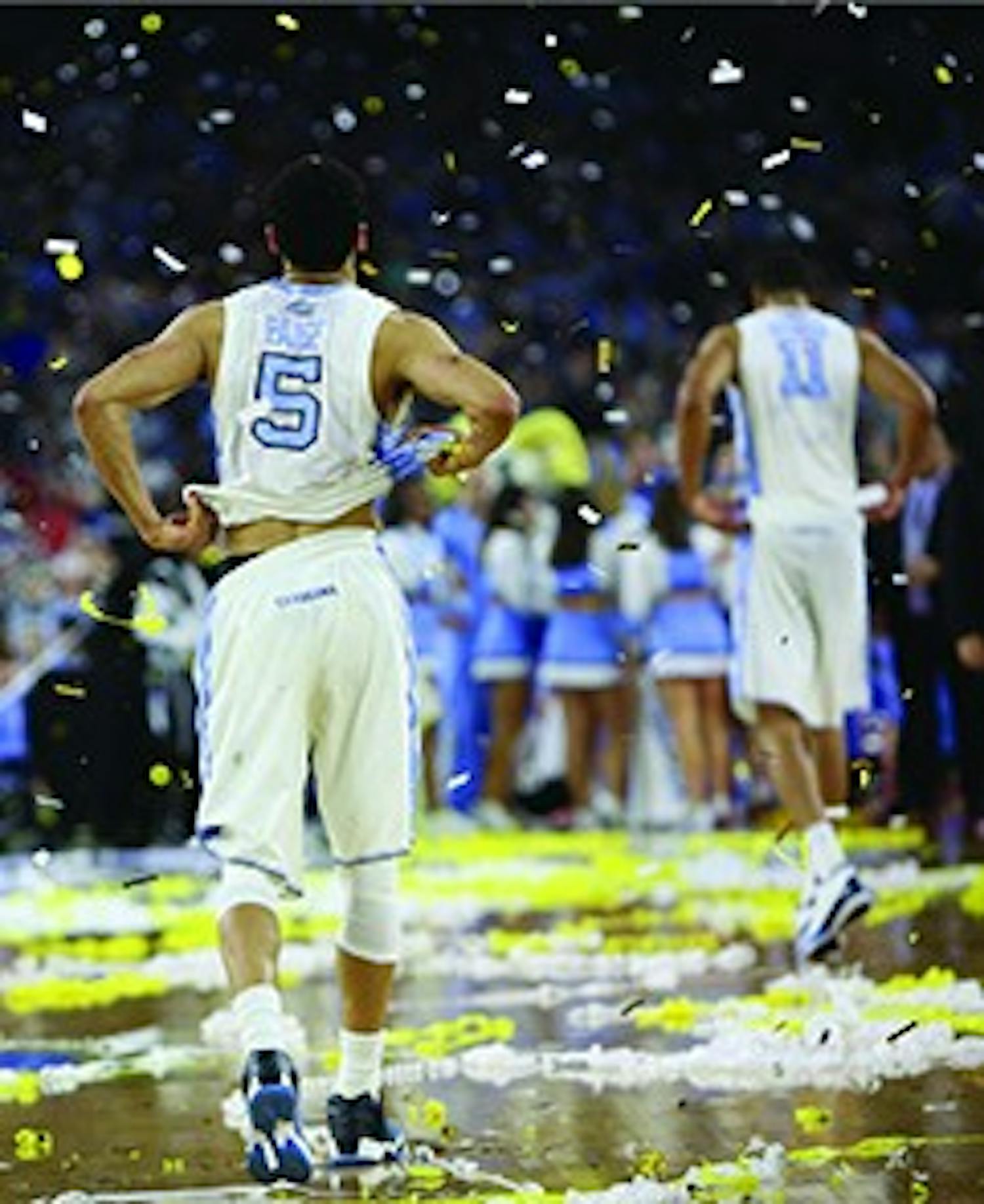 Seniors Marcus Paige (5) and Brice Johnson (11) walk off the court after the 74-77 loss against Villanova.