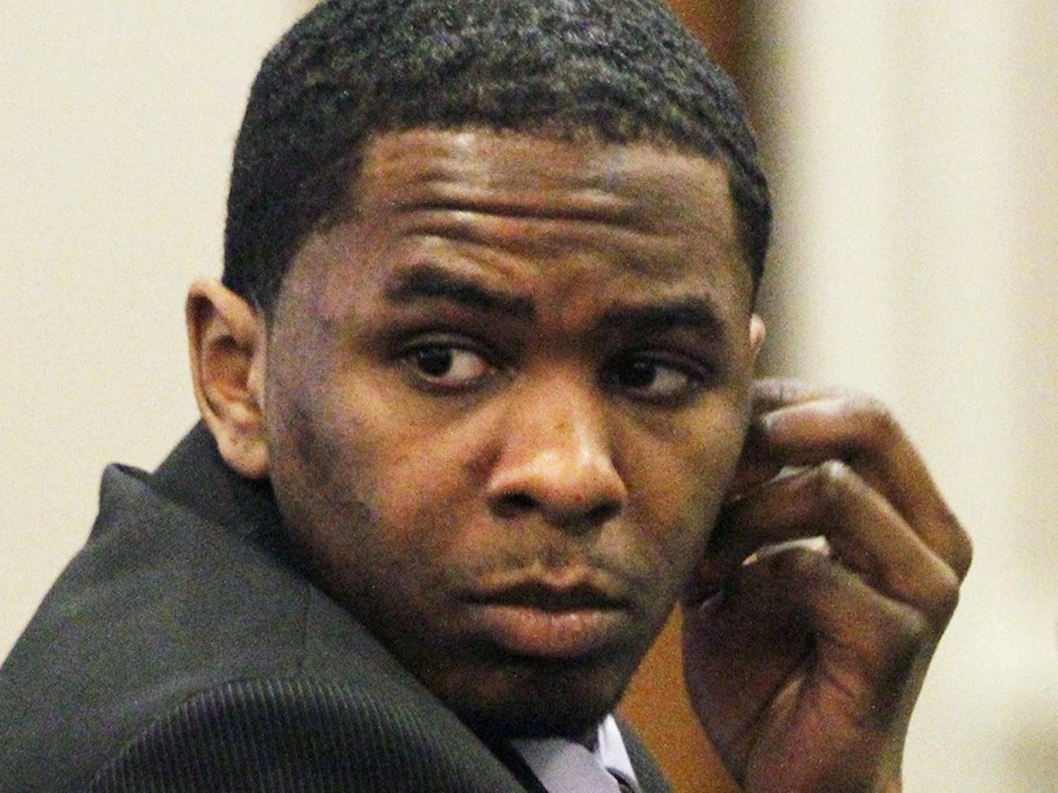 Defendant Laurence Alvin Lovette, 21, turns to watch courtroom activity behind the defense table during a break in the second day of testimony Thursday, Dec. 8, 2011 in the Battle Courtroom, Hillsborough, NC. Lovette, from Durham,NC  is one of two men charged in the kidnap, robbery and murder of UNC student body president Eve Carson on March 5, 2008. 