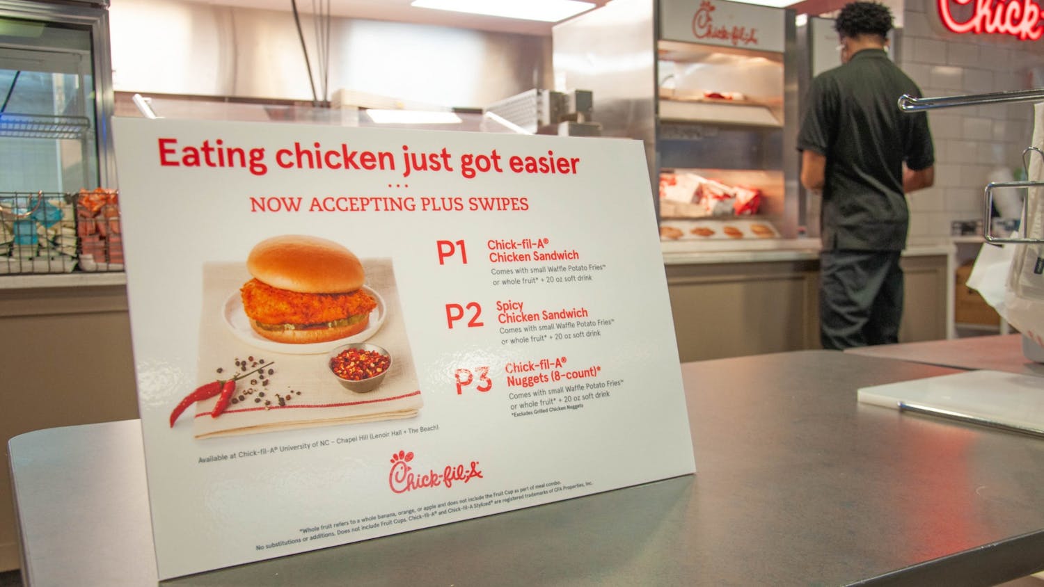 Employees at Chick-Fil-A in Lenoir Dining Hall serve students on February 1, 2021. Recently, Carolina Dining Services increased the PLUS swipes available to meal plan holders from two to seven per week.