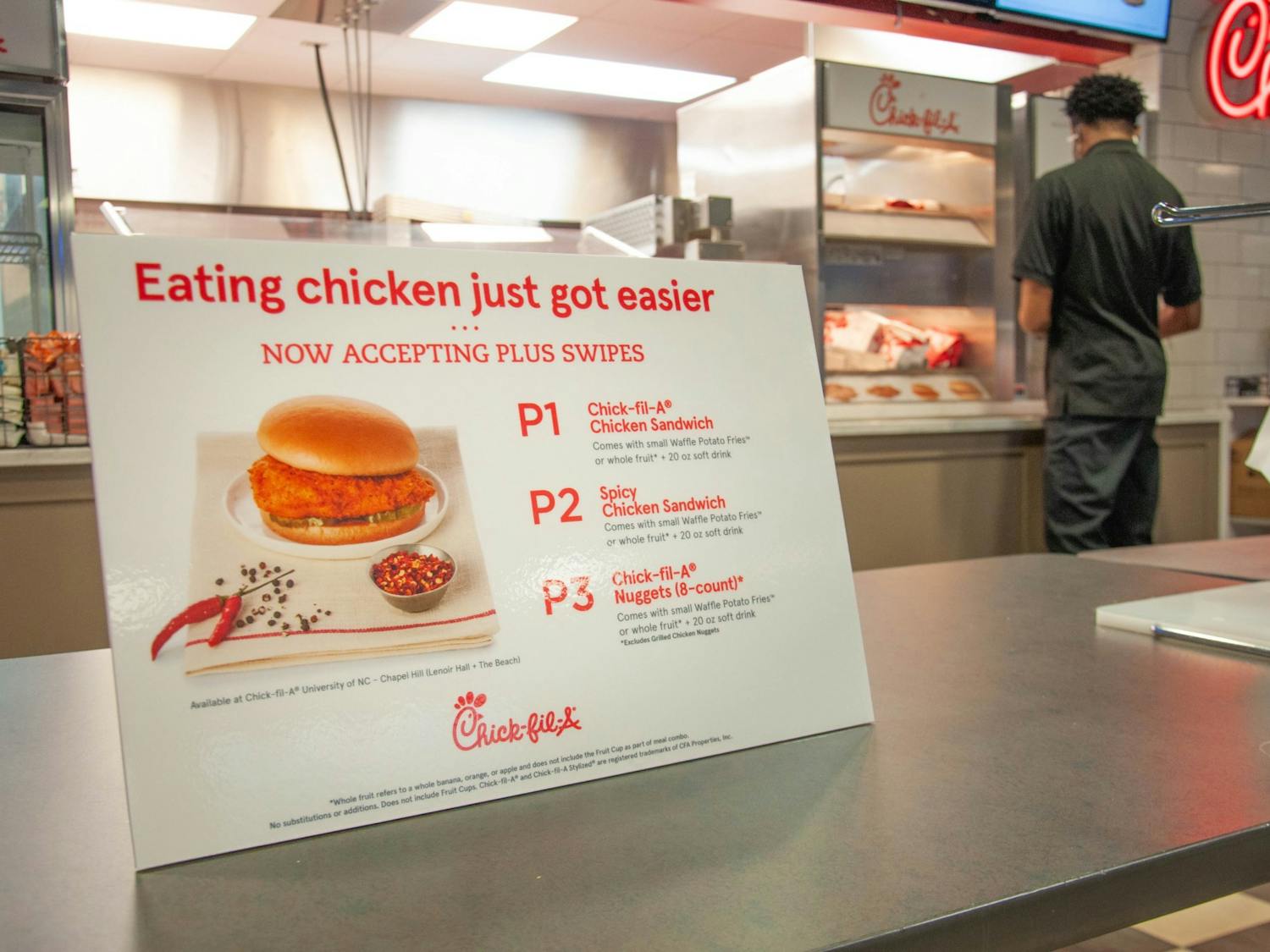 Employees at Chick-Fil-A in Lenoir Dining Hall serve students on February 1, 2021. Recently, Carolina Dining Services increased the PLUS swipes available to meal plan holders from two to seven per week.