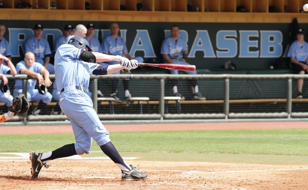 Third baseman Colin Moran connects with the ball in the bottom of the fourth on April 3. The Tar Heels completed a three-game sweep of the Clemson Tigers with a 5-4 victory on.