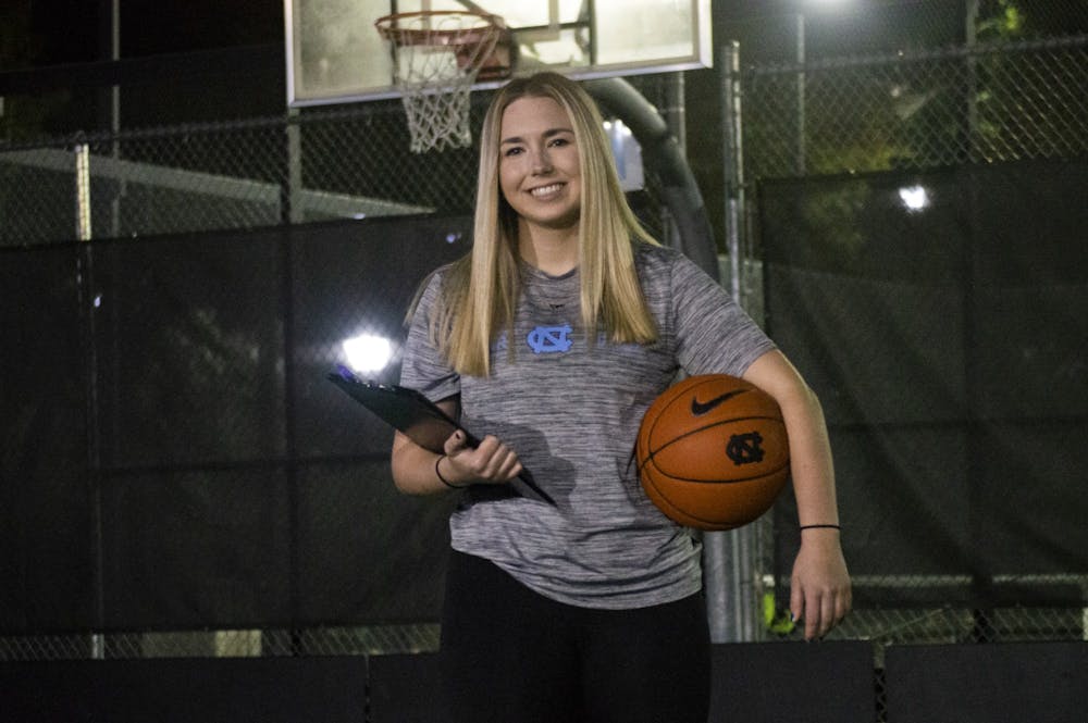 Kiersten Steinbacher, a Senior Exercise and Sport Science Major and Head Student Manager for Carolina Basketball, poses with her basketball and manager clipboard at the courts outside of Ram Village on Monday, Nov. 2, 2020.