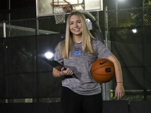 Kiersten Steinbacher, a Senior Exercise and Sport Science Major and Head Student Manager for Carolina Basketball, poses with her basketball and manager clipboard at the courts outside of Ram Village on Monday, Nov. 2, 2020.