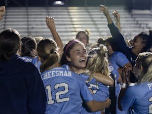 UNC right back Emily Moxley celebrates with teammates after defeating Duke in a penalty kick shootout in the ACC Championship semifinals on Thursday, Nov. 3.