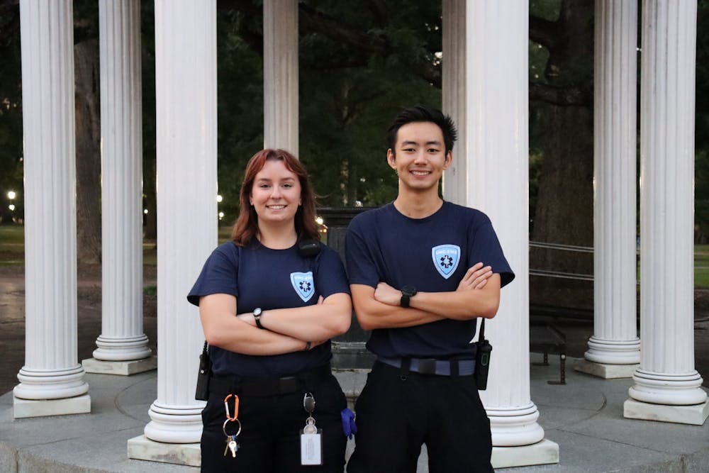 Hannah Jones and Henry Li, both EMTs for UNC, pose for a portrait in front of the Bell Tower on UNC's campus on Thursday, Sept. 15, 2022.