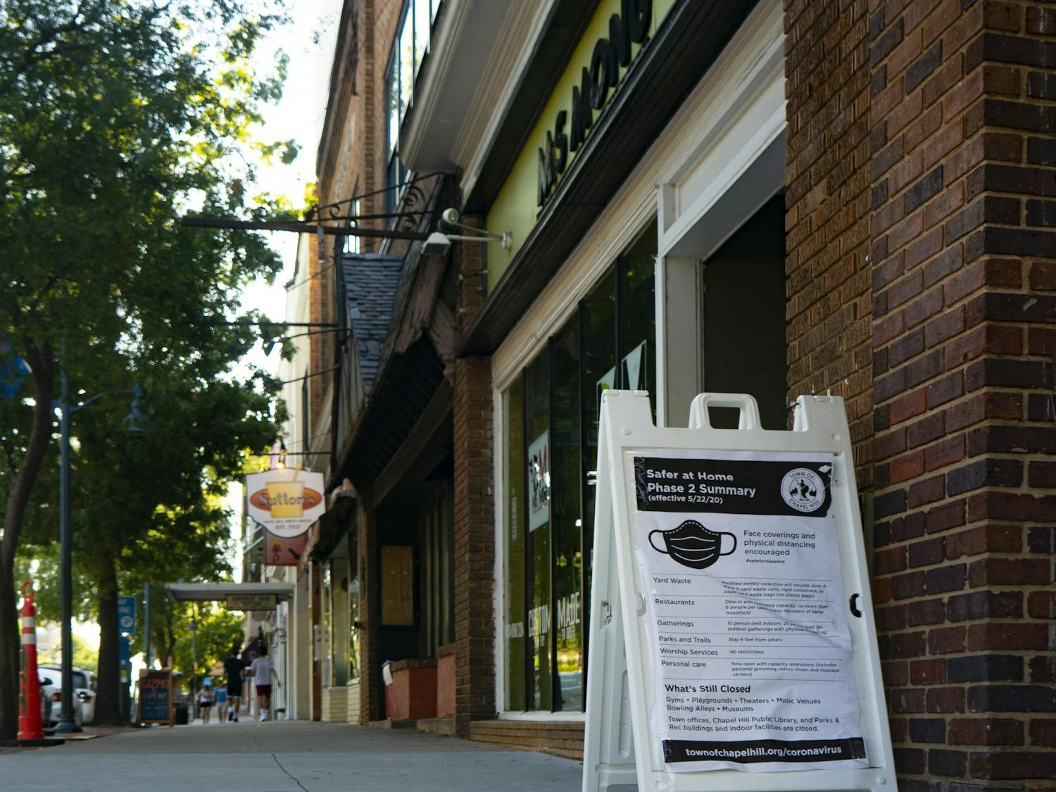 A sign on East Franklin Street provides information about safety precautions against COVID-19 on Sunday, June 7, 2020.
