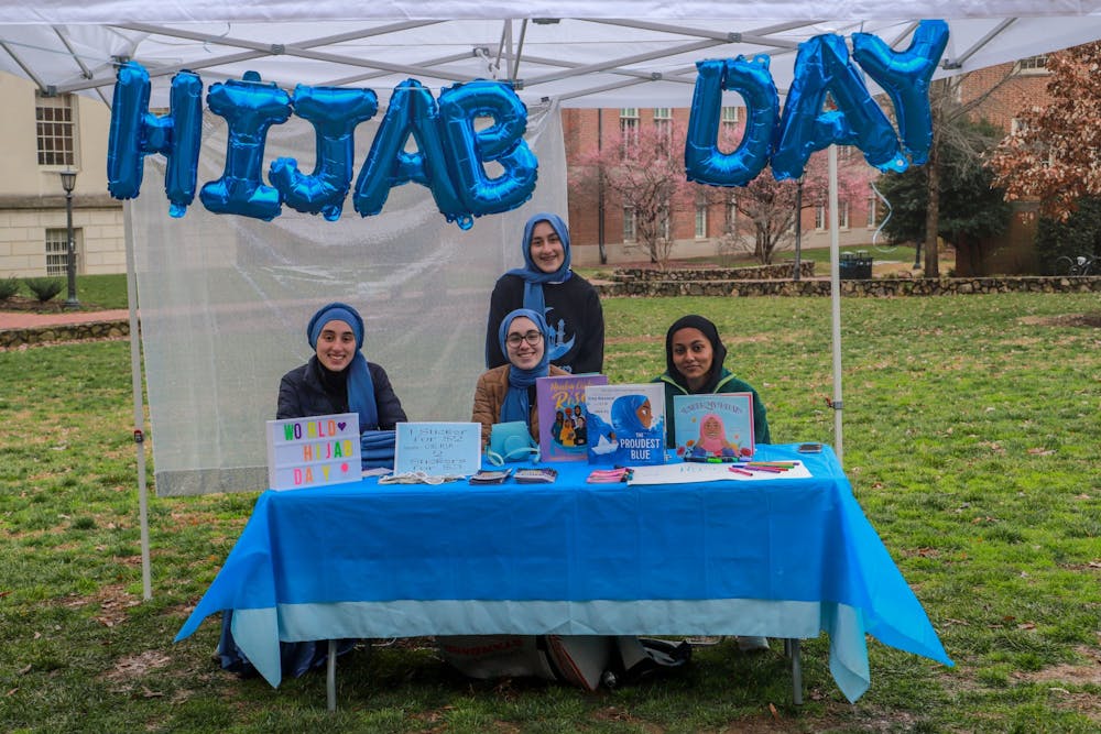 <p>UNC senior computer science major Rida Bayraktar, first-year neuroscience major Mina Bayraktar first-year Huss Kamal, and Alyse Bayraktar, 13 years old from Cary, are pictured on National Hijab Day on Feb. 1, 2023.</p>