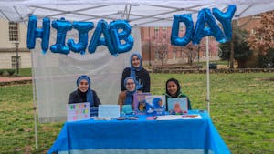 UNC senior computer science major Rita Bayraktar, first-year neuroscience major Mina Bayraktar first-year Huss Kamal, and Alyse Bayraktar, 13 years old from Cary, are pictured on National Hijab Day on Feb. 1, 2023.