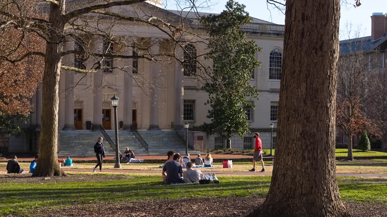 Students sit on quad in front of Wilson Library on Tuesday, Feb. 16, 2021.