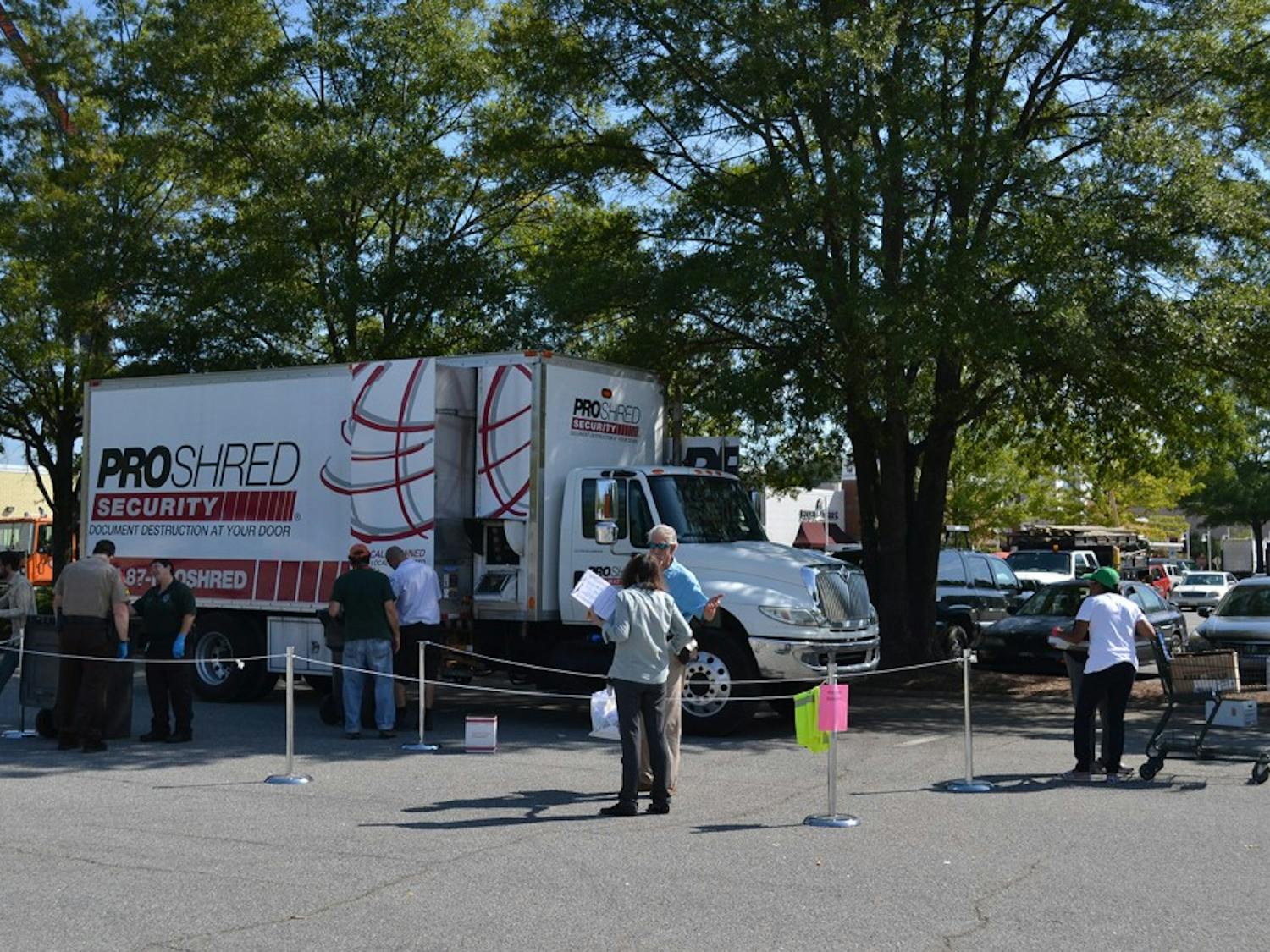 People gather at University Place on Thursday to shred documents, with the assistance of volunteers and police.
