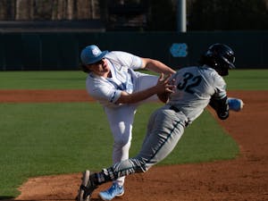 UNC first baseman Hunter Stokely (45) goes to tag for an out during UNC's first in a three game series against Coastal Carolina on March 4, 2022, in Chapel Hill, NC. UNC won that game 4-3.