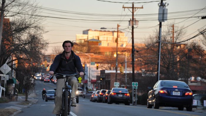 UNC student George Ellington rides his bike down West Main Street in Carrboro.