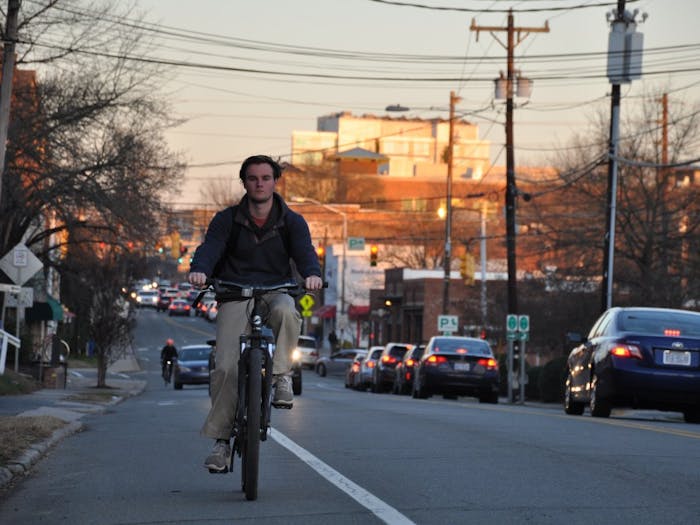 UNC student George Ellington rides his bike down West Main Street in Carrboro.