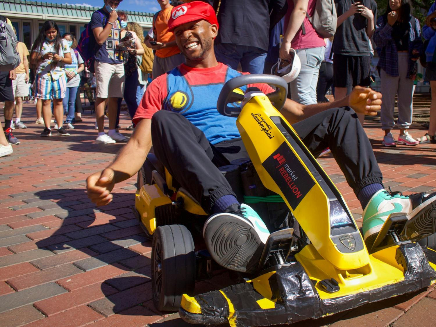 Joshua Schaffer, known virally as WeathermanJosh, dresses as Mario and rides a go-kart through the Pit on Sept. 22. "Make sure to subscribe to my YouTube channel," he prompted people as they stopped for pictures.