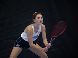 Junior Fiona Crawley waits for her opponent’s serve during her singles match against Elon University’s Sibel Tanik at the Cone-Kenfield Tennis Center on  Friday, January 13, 2023. UNC beat Elon 4-2.