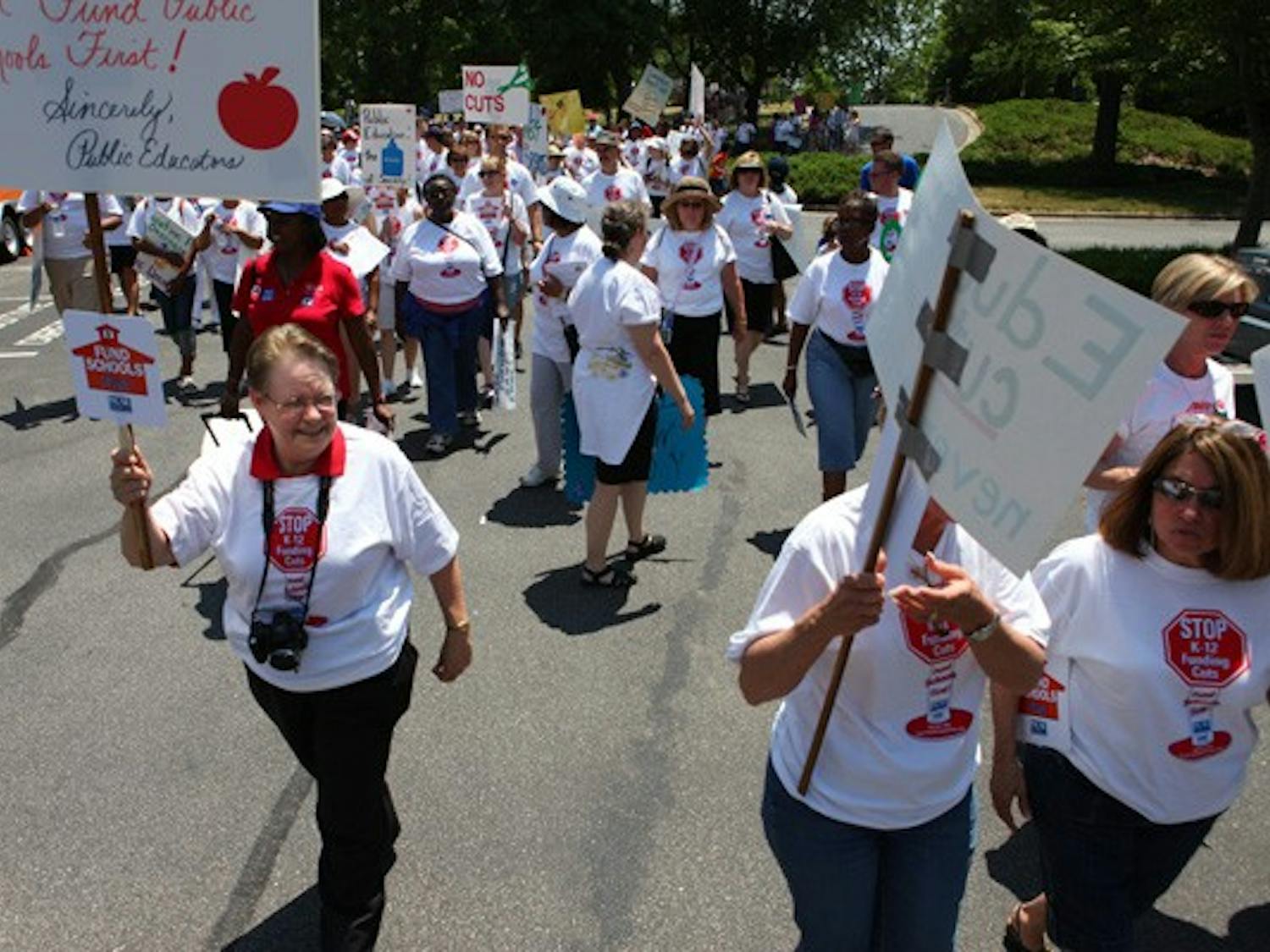 English teacher Diane Leazer marches with a crowd of supporters for K-12 public education funding. DTH/Stephen Mitchell
