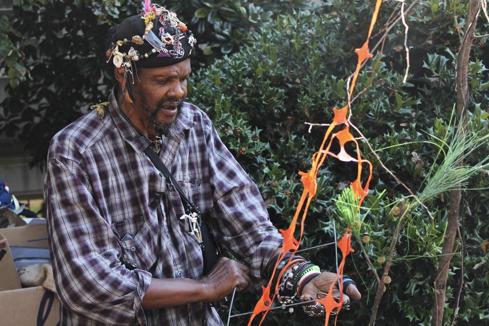Lonnie Holley, a nationally known visual artist and musician from Birmingham Alabama, creates new pieces of art in near Wilson library.  The Southern Folklife Collection donated old and broken materials for Holley to incorporate into his work.